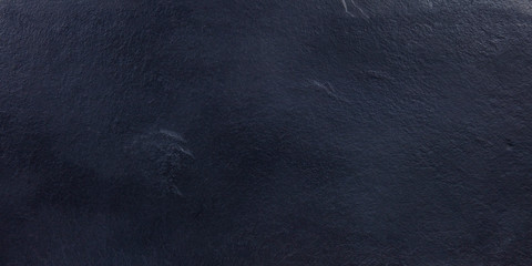 An abstract black slate background, a dark texture with copy space, panoramic image