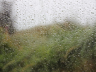 Raindrops on Window with Green Garden Background