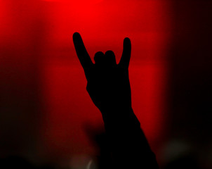 Hand silhouette at a rock concert as background