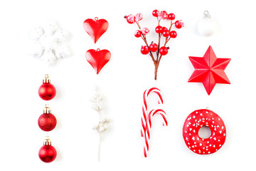 Red Christmas decorations isolated on white. Red holly berries, snowflake, glass baubles on white background, top view