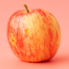 Red apple on a pink background