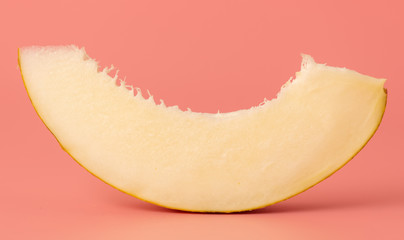 Ripe tasty melon on a pink background