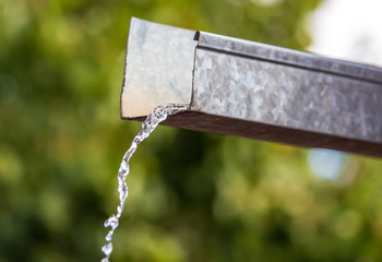 Water pours from the drain on the house