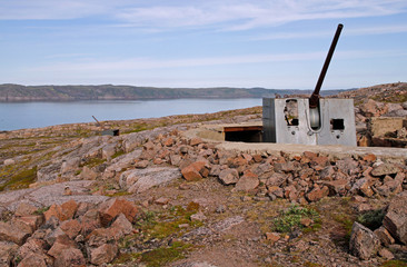 Soviet time artillery at the shore of Barents Sea nearby Teriberka