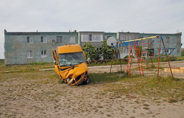 yellow damaged van in russian village Teriberka