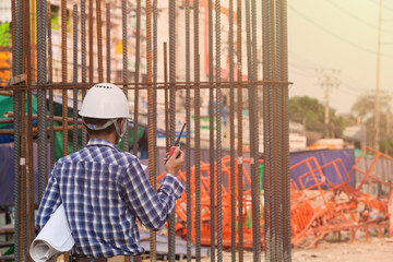 the engineer controlling the electric train is using radio to communicate with foreman in the construction project
