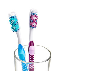 Two new toothbrush in glass isolated on a white background