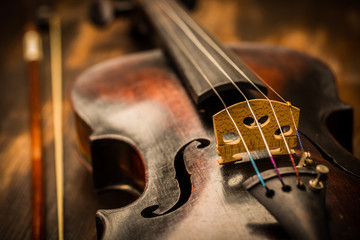 Fototapeta premium Detail of old violin and bow in vintage style