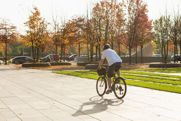 Man on bicycle in autumn park
