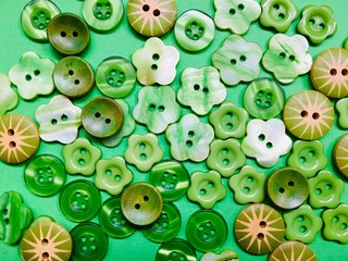 Assortment of green plastic buttons