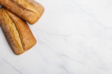Loafs of bread on white marble