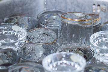 Abstract background a lot of glasses and wine glasses in a sink