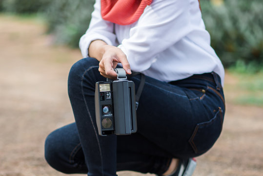 Polaroid camera in a woman hand for your design