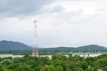 broadcasting system post and communication high tower for antenna transmission center and wireless signal technology on community with nature tree mountain and river at countryside with space