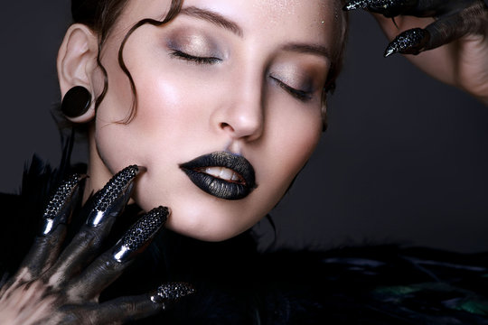 Black lips. Halloween Makeup. Luxury beautiful woman with dark lipstick and claws. Beauty stylish girl with closed eyes