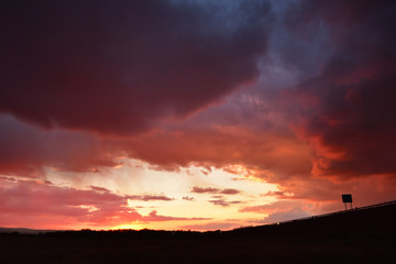 Dramatic sunset with colorful clouds in early Autumn