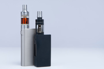 Two vapes on a white background. The concept of vaping. VAPE shop. Smoking electronic cigarettes....