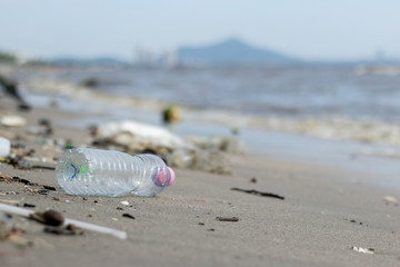 old plastic bottle on the beach.The dirty of the sand. trash litter outdoor
