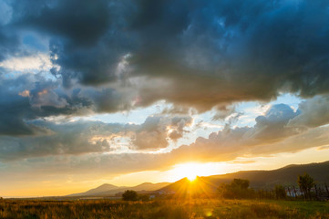 Rural sunset with colorful clouds.