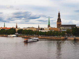 Riga, Latvia. Summer. Panoramic view of the city. The streets of the old city aerial view. River, houses, old churches, blue sky. Postcard. Free space for text.