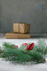 Christmas background. Gift box with a sprig of a Christmas tree and red decorations