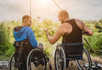 Handicapped men fishing at a lake. Wheelchair. Camping.