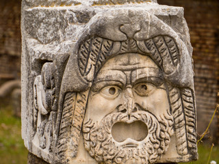 Mask detail, Roman Theater, Ancient Archaeological Site of Ostia Antica in Rome, Italy