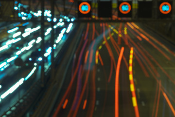 The lights of blurred motion of cars on the highway. Long exposure of big urban night traffic in the city. In the summer urban highway filled cars. Rush hours. To be late. 