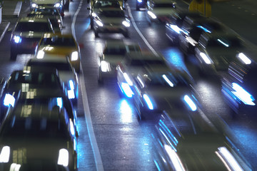 The lights of blurred motion of cars on the highway. Long exposure of big urban night traffic in...