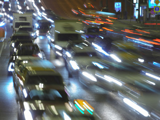 The lights of blurred motion of cars on the highway. Long exposure of big urban night traffic in...