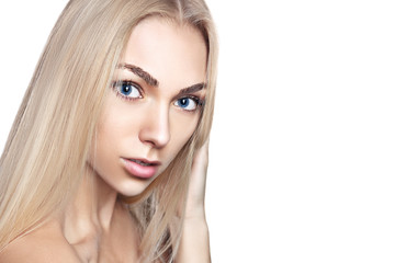 Fototapeta premium Portrait of young beautiful girl with long blond hair and natural make-up
