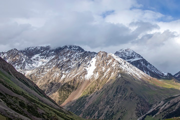 Mountain view with snow-capped peaks against a cloudy sky