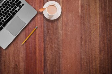 cup of coffee and notebook on wooden table
