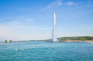Jet d'Eau, famous water fountain in Geneva, Switzerland located on Lake Geneva. Symbol of the Swiss city. Famous landmark and tourist attraction photographed on a sunny summer day