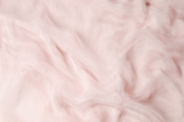 Soft smooth pink silk fabric background. Fabric texture.