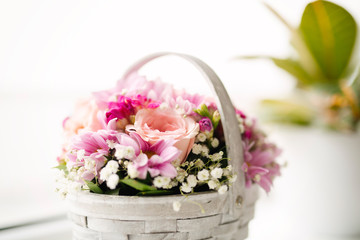 Beautiful pink flowers in a basket, vintage style.