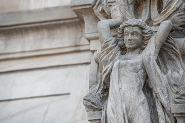 Wall figure of beautiful woman holding a big wreath at historical museum in Magdeburg, Germany