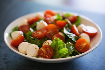 Salad with mozzarella balls tomatoes and mix salad