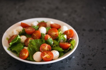 Salad with mozzarella balls tomatoes and mix salad