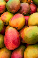Food background of Variety of fresh ripe Mango Fruits at the spanish weekly Market. Close up shot