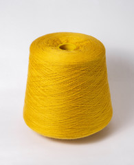 bobbin of yarn on a white background. Side view.Textile reel on isolated white background.