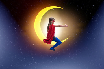 Fototapeta na wymiar Superhero kid sitting on the moon crescent