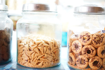 Traditional snack look like fortune cookies on big jar