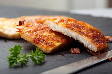 Pork schnitzel on a black slate