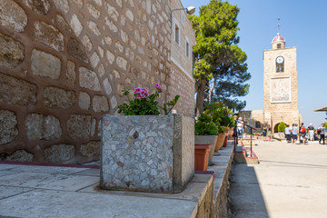 Decorative pot with geraniums in the courtyard of the Greek Orthodox Monastery of the...