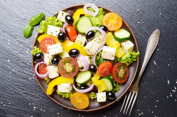 Top view at Mediterranean diet dish greek salad on slate tray