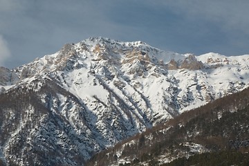 Fototapeta na wymiar Snowy mountains in winter weather