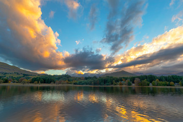 Golden colored clouds at sunset over the lake