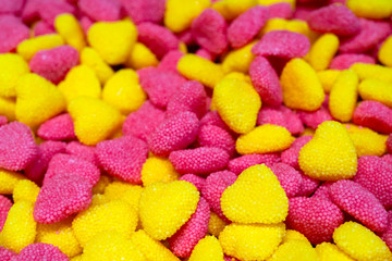 Pink and yellow heart shaped candies.