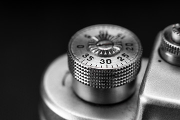 Retro vintage photo camera parts, metal aluminum, macro shot. Film antiques, the past era of photographers. On a black background, view from the front.